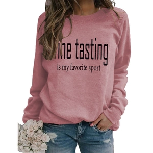 Close-up of WINE TASTING IS MY FAVORITE SPORT print on dusty rose sweatshirt
