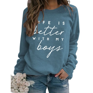 Close-up of LIFE IS BETTER lettering on a navy crewneck sweatshirt with soft fabric
