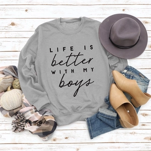 Flat lay of grey crewneck sweatshirt featuring Life Is Better printed lettering