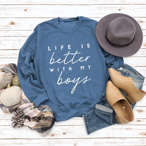 Detail of blue crewneck sweatshirt featuring white Life Is Better With My Boys print