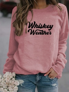 Close-up of retro Whiskey Weather letter print on dusty pink oversized sweatshirt