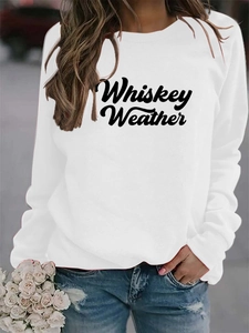 Close-up of Whiskey Weather letter print on a white casual crewneck sweatshirt