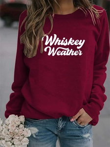 Detailed texture of burgundy Whiskey Weather sweatshirt with soft white script lettering