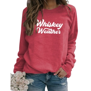 Detail of red crewneck sweatshirt featuring white Whiskey Weather lettering print