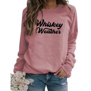 Close-up of Whiskey Weather letter print on mauve pink oversized sweatshirt