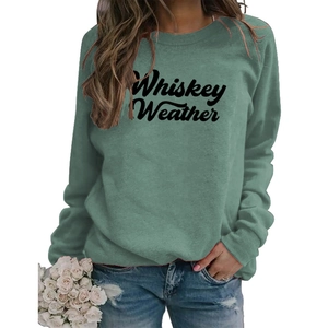 Detail of Whiskey Weather script print on sage green crewneck sweatshirt with white roses