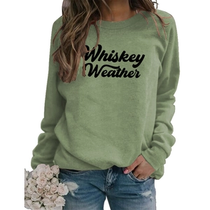 Close-up of Whiskey Weather green sweatshirt with raglan sleeves and cursive lettering