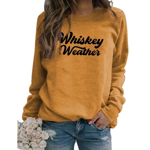 Detail of Whiskey Weather lettering on ginger yellow long sleeve casual sweatshirt