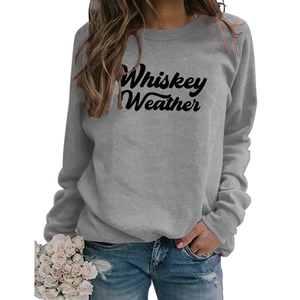 Close-up of gray crewneck sweatshirt with Whiskey Weather text and white roses