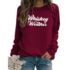 Detail of Whiskey Weather white cursive lettering on a burgundy crewneck sweatshirt
