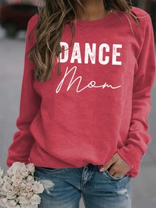 Close-up of red crewneck sweatshirt with white DANCE Mom print and distressed lettering