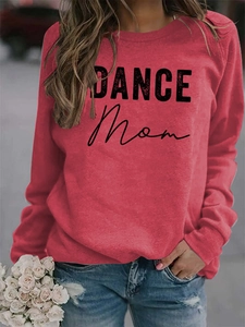 Detail of red crewneck sweatshirt featuring black DANCE MOM lettering and casual fit