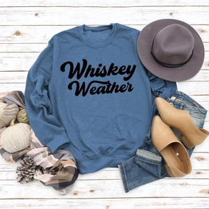 Flat lay of Whiskey Weather lettered sweatshirt with seasonal fashion accessories