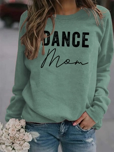 Close-up of sage green sweatshirt featuring black DANCE MOM letter print and soft fabric