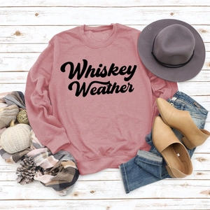 Flat lay detail of pink Whiskey Weather sweatshirt with autumn boots and accessories