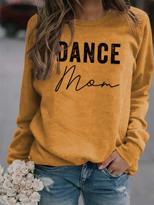 Detail of the high-quality cotton fabric and DANCE Mom print on the mustard sweatshirt