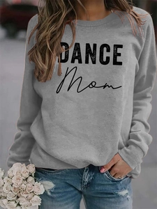 Close-up of DANCE MOM print on grey crewneck sweatshirt with casual outdoor street styling