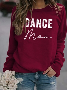 Detail shot of the white DANCE MOM print on a burgundy crewneck sweatshirt for women