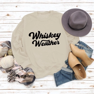 Flat lay of beige Whiskey Weather crewneck sweatshirt styled with autumn fashion accessories