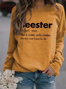 Detail of ginger yellow crewneck sweatshirt with Seester definition printed on the front
