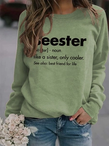 Detail of avocado green sweatshirt featuring Seester dictionary style chest print