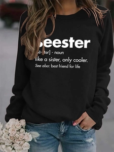Detail shot of black crewneck sweatshirt featuring white Seester creative text print