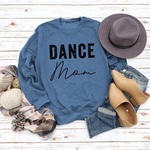 Flat lay of blue DANCE MOM sweatshirt styled with a fedora, scarf and casual shoes