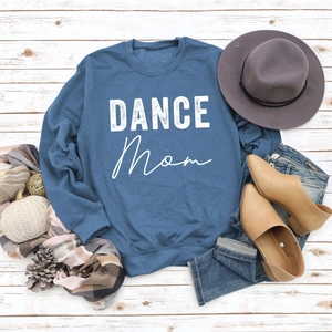Flat lay of navy DANCE MOM sweatshirt with stylish autumn accessories on wood background