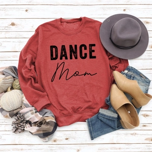 Flat lay of red Dance Mom sweatshirt styled with autumn accessories and casual jeans