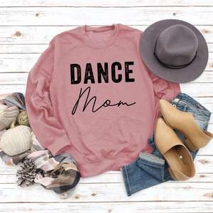 Flat lay of Dance Mom sweatshirt on white wood with autumn props and denim
