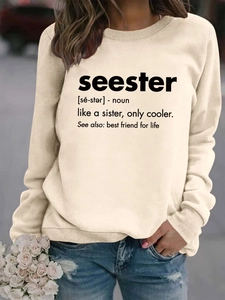 Detail showing 'seester' text print on cream crewneck sweatshirt with casual styling