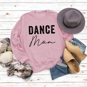 Flat lay of pink Dance Mom sweatshirt with casual autumn boots and stylish accessories