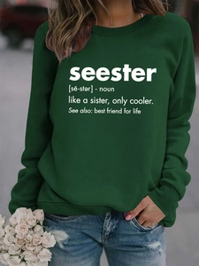 Detail of ribbed cuffs and Seester text print on a dark green crewneck sweatshirt