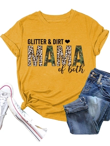 Flat lay of yellow t-shirt with GLITTER & DIRT MAMA print, denim jeans, and white sneakers