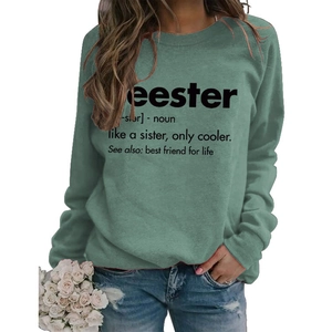 Detail of sage green sweatshirt featuring black letter print and soft knit texture