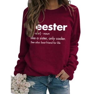 Detail of maroon crewneck sweatshirt featuring white Seester graphic print and loose fit
