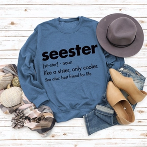 Flat lay of navy blue Seester sweatshirt styled with winter accessories on wood