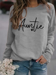 Detail of grey crewneck sweatshirt featuring black Auntie lettering and heart print
