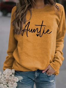 Detail of Auntie print and heart graphic on ginger yellow crew neck sweatshirt