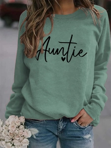 Detail of the soft Morandi green fabric and Auntie heart print on a women's sweatshirt