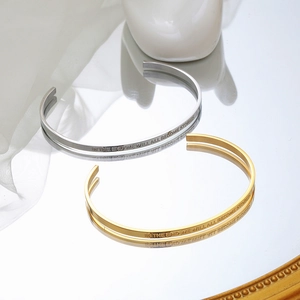Polished silver and gold C-shaped open bracelets with engraved inspirational quotes