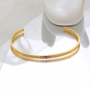C-shaped gold-plated stainless steel cuff bracelet with engraved inspirational quote
