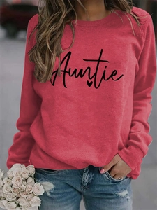 Detail of the Auntie script print and heart graphic on this red crewneck sweatshirt