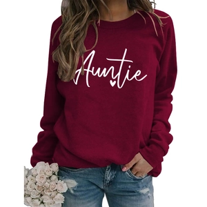 Detail of burgundy Auntie sweatshirt featuring white script text and heart on soft fabric