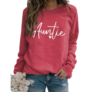 Close-up detail of white handwritten Auntie text and heart on dark red sweatshirt