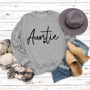 Flat lay of grey crewneck sweatshirt with Auntie print and autumn fashion accessories