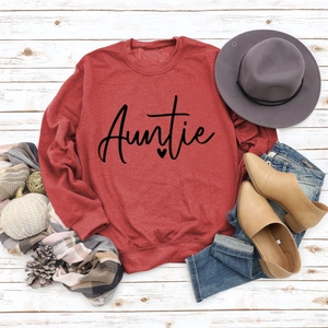 Flat lay of red Auntie letter sweatshirt styled with autumn accessories and hat