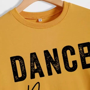 Yellow DANCE MOM crewneck sweatshirt with distressed black letters on wood hanger