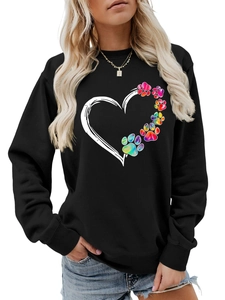 Detail of heart and rainbow paw print graphic on women's black long sleeve sweatshirt
