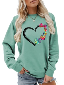 Detail of mint green sweatshirt featuring a heart and colorful rainbow dog paw prints